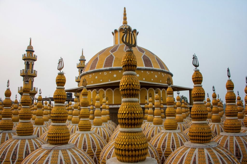 Colorful domes of a Rawalpindi mosque with intricate patterns, showcasing unique architecture.